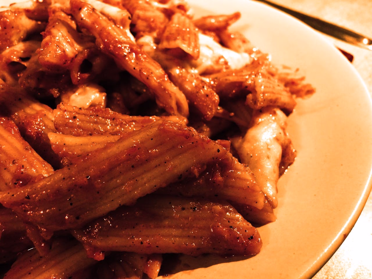 pasta-dish-432072 Close-up of mouthwatering penne pasta in red sauce, perfect for Italian cuisine lovers.